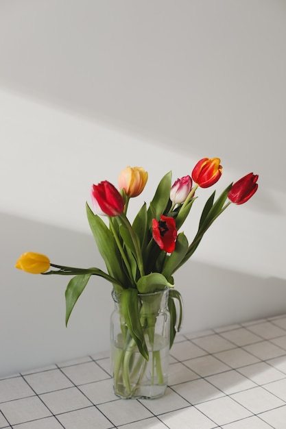 Bouquet of tulips in a vase at home.