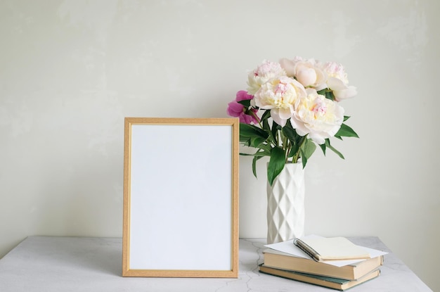 Bouquet of white peonies in a vase on grey background