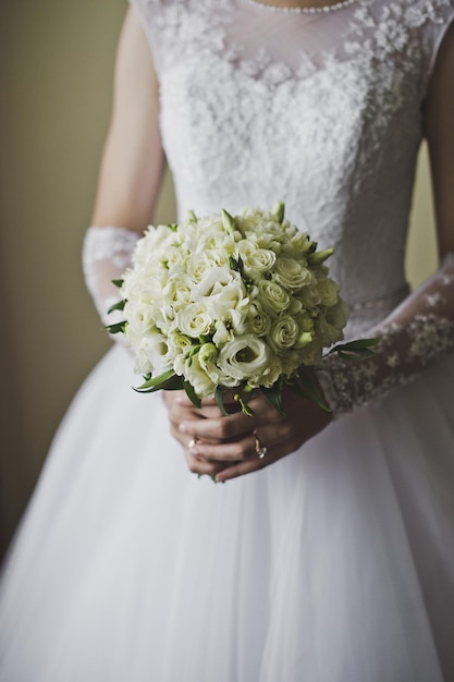 A bouquet of white roses in hands of bride 5141