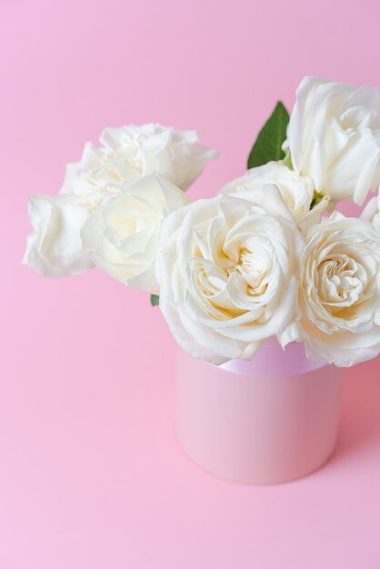 Bouquet white roses on pink background in a box Mother's Day Valentine's Day