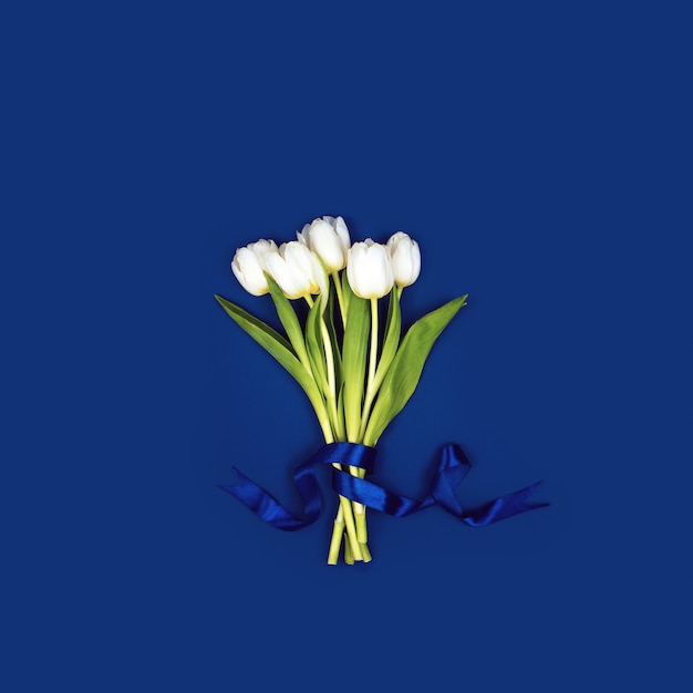 A bouquet of white tulips tied with a ribbon.