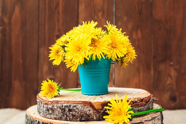 Bouquet of yellow dandelions in a bucket