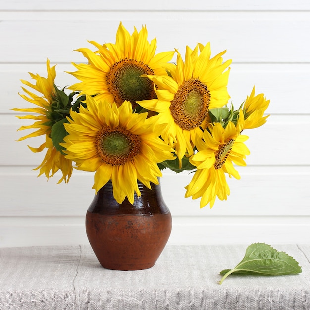 Bouquet of yellow sunflowers on the table a light rustic interior