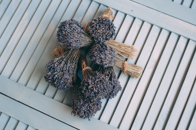 Bouquets of dry lavender on wooden background. 