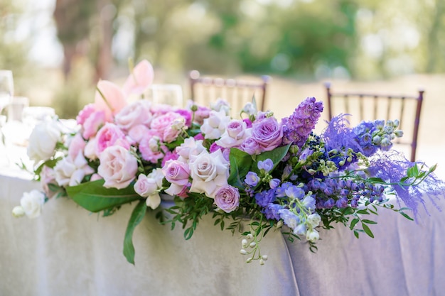 Bouquets of fresh flowers decoration of the festive table. Celebrating an open air party. Decor Details