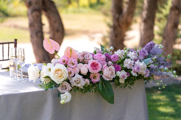 Bouquets of fresh flowers decoration of the festive table. Celebrating an open air party. Decor Details