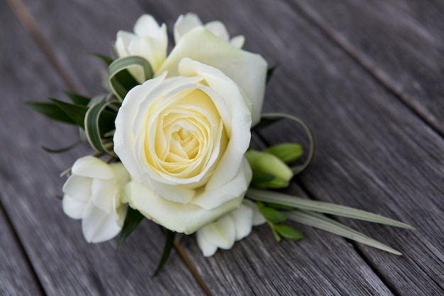 A boutonniere button hole flower a cream rose