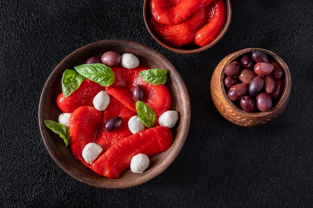 Bowl of baked bell peppers with mozarella and kalamata olives