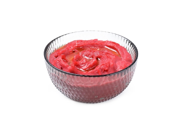 Bowl of beet hummus isolated on white background