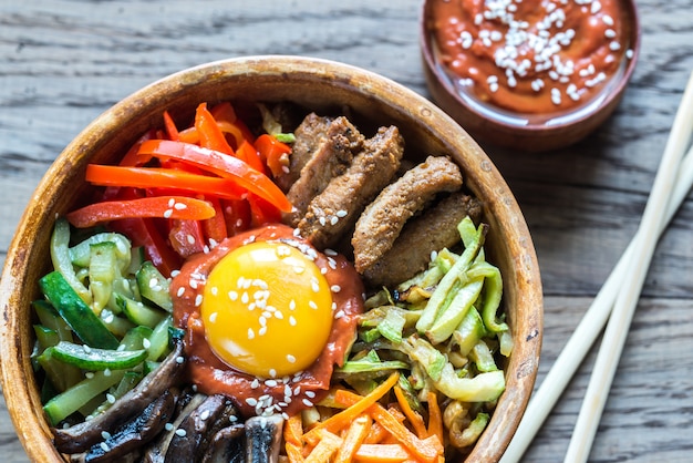 Bowl of bibimbap on wooden table