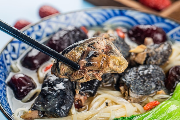 A bowl of black chicken noodles