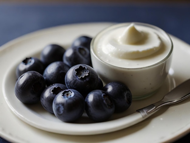 a bowl of blueberries with a cup of cream on it