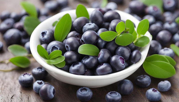 a bowl of blueberries with leaves and a small green leaf