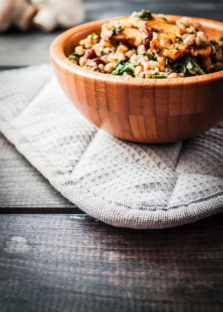 bowl of boiled buckwheat with fried champignon, spinach and red beans