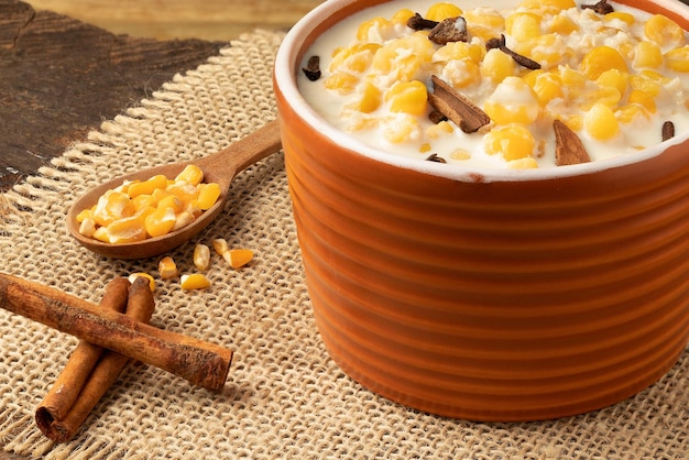 Bowl of Brazilian canjica made with corn coconut flake and cinnamon