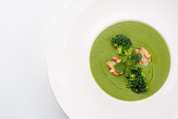 Bowl of broccoli cream soup with walnut