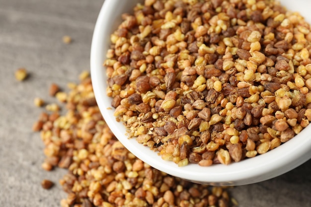 Bowl of  buckwheat tea on textured background, close up