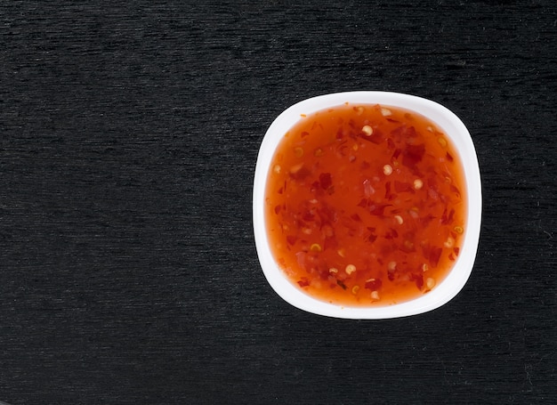 bowl of chili sauce on wood background