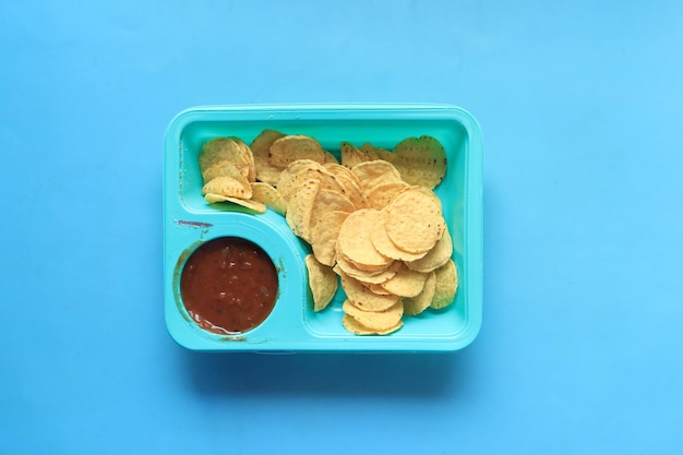 A bowl of chips and salsa on table