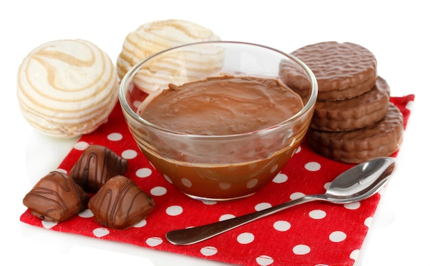 Bowl of chocolate and sweets isolated on white