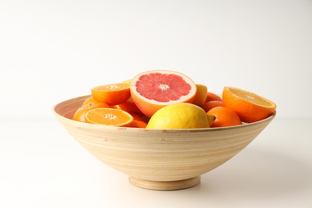 Bowl of citrus fruits on white table