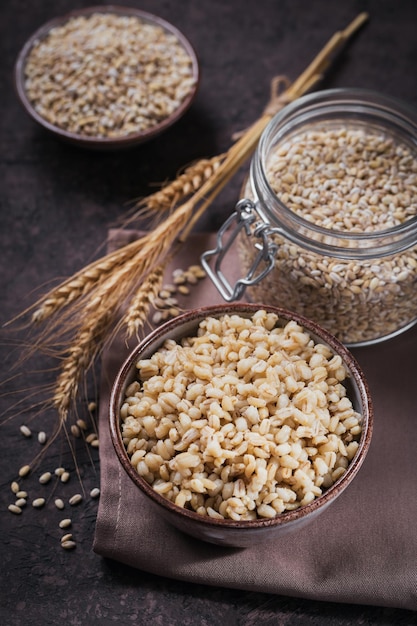 Bowl of cooked peeled barley grains porridge