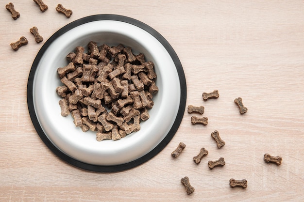 A bowl of dog food on a wooden floor