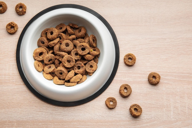 A bowl of dog food on a wooden floor