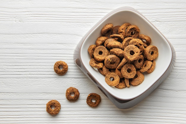 A bowl of dog food on a wooden floor