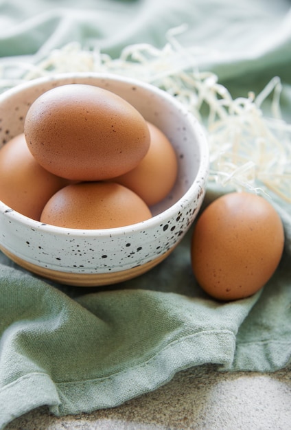 Bowl of eggs on concrete background