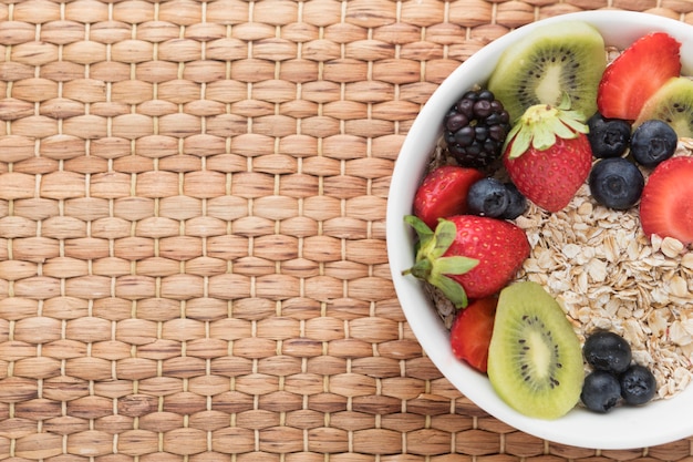 Bowl filled with fruit and cereals top view