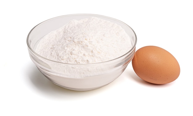 Bowl of flour with a whole egg