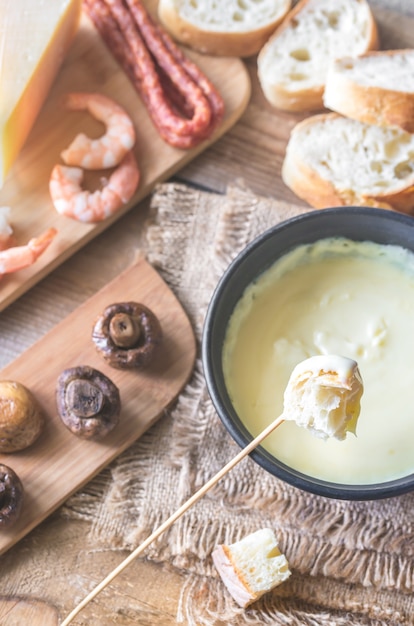 Bowl of fondue with appetizers