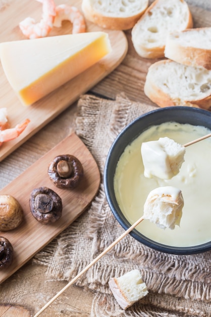 Bowl of fondue with appetizers