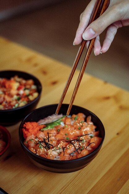 A bowl of food with chopsticks on it