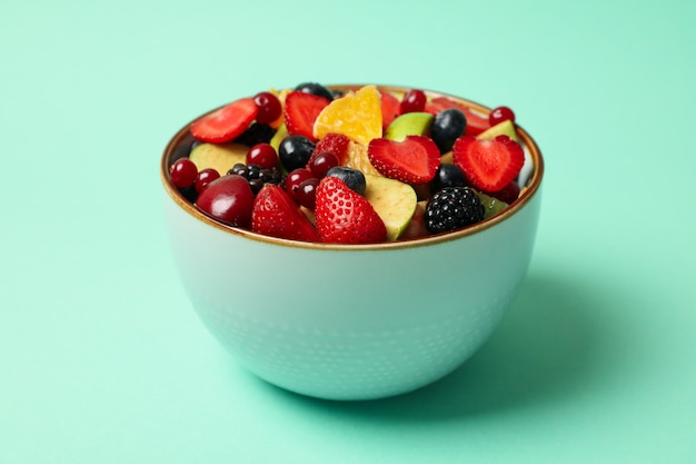 Bowl of fresh fruit salad on mint