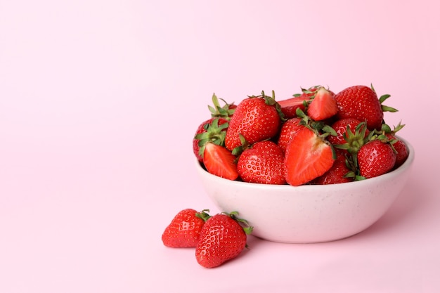 Bowl of fresh strawberry on pink