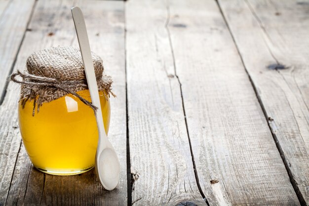 Bowl of honey on wooden table. Symbol of healthy living and natural medicine. Aromatic and tasty.