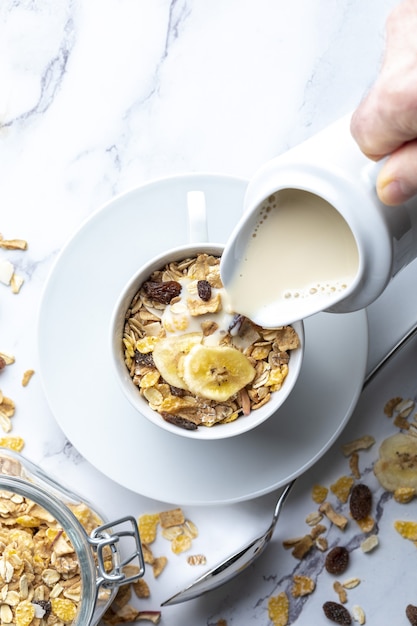 Bowl of milk with whole grains for breakfast Muesli with dried fruits and dried fruits With copy space