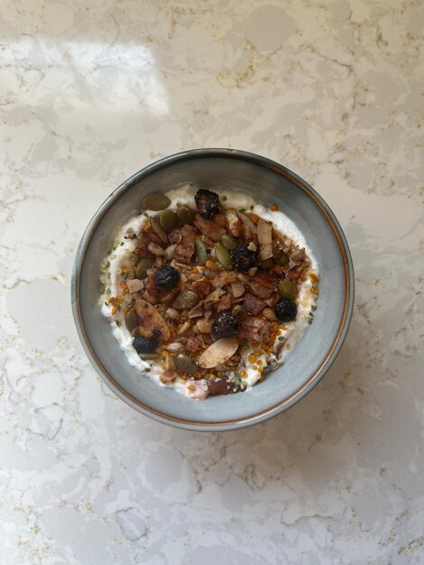 a bowl of oatmeal with nuts and raisins on a table