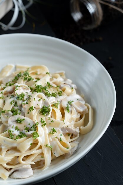 a bowl of pasta with parsley on top of it