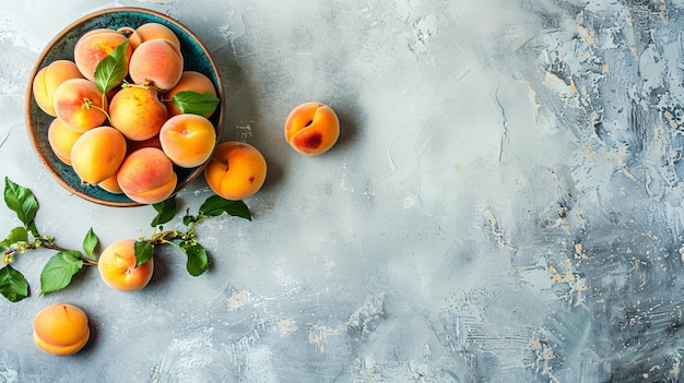 a bowl of peaches with leaves on a table