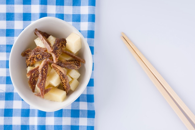 Bowl of pieces of tasty dried fig and pieces of ewe's cheese 