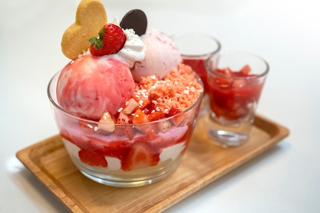 Bowl of pink strawberry ice cream and fresh strawberry