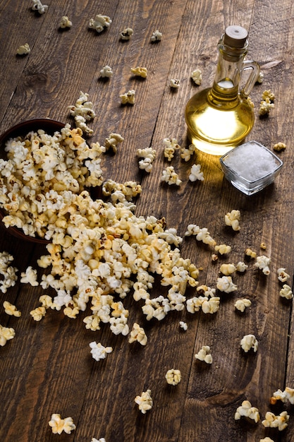 A bowl of popcorn on a wooden table