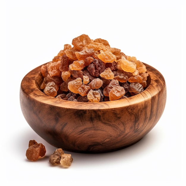 A bowl of raisins sits on a white background.