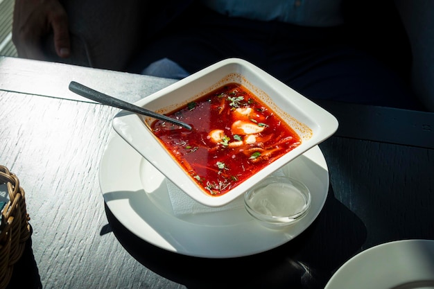 Bowl of red beet root soup borsch with white cream Beet Root delicious soup Traditional Ukrain food cuisine Traditional Ukrainian Russian borscht