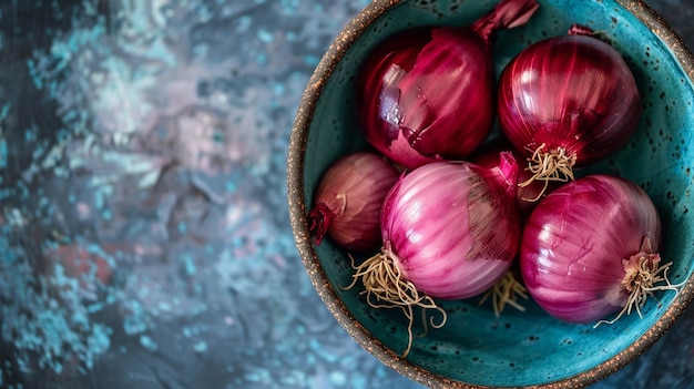 a bowl of red onions with a green rim and a blue rim