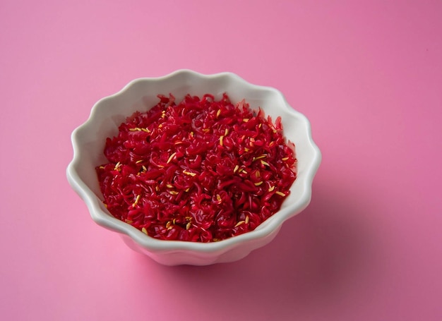 A bowl of red and yellow flowers with yellow and red sprinkles.