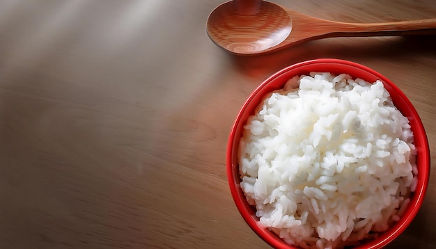 a bowl of rice with a spoon and a spoon on a table